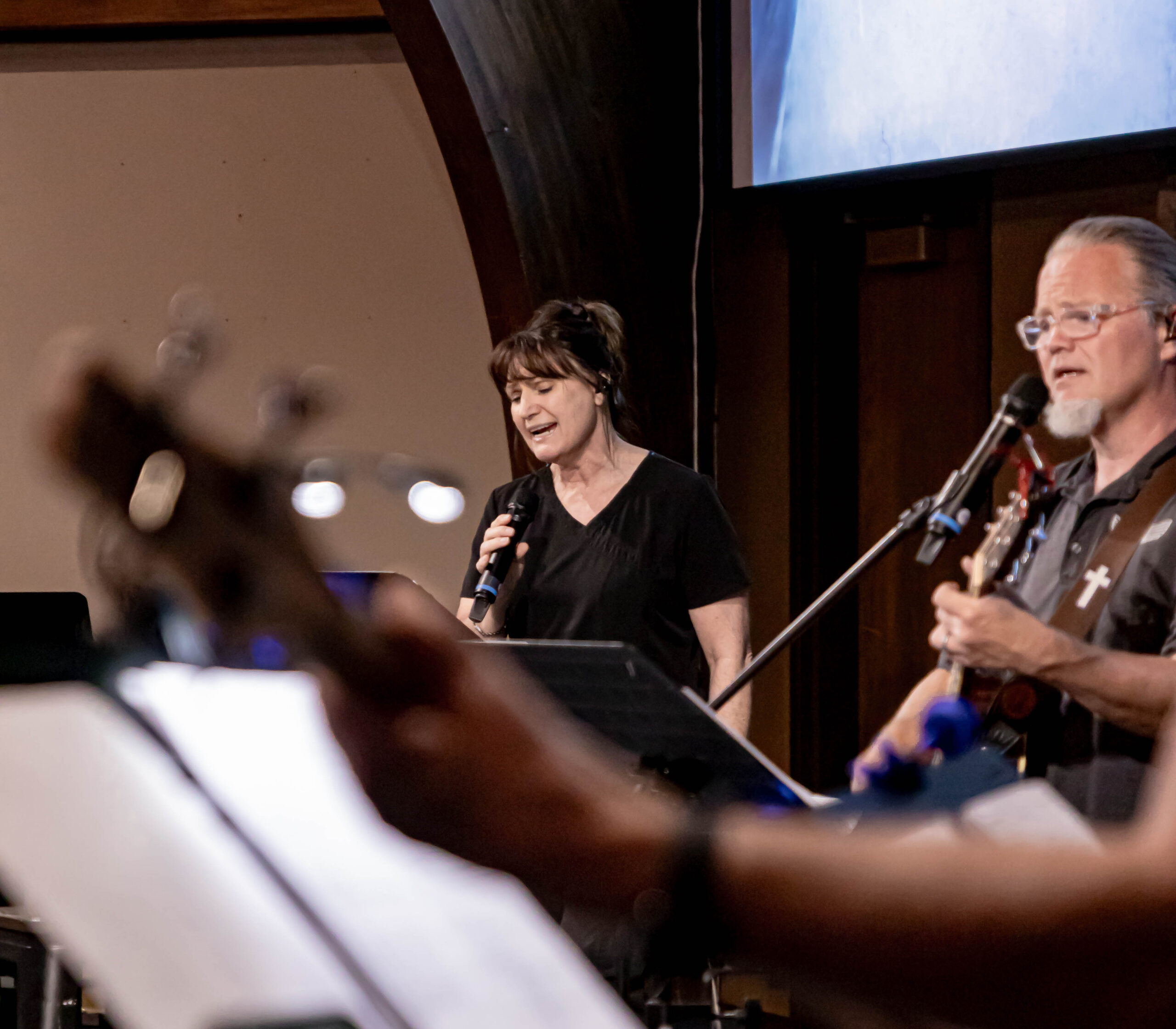 members of a band singing and playing instruments